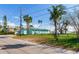 Large side yard with tropical landscaping, offering privacy at 409 161St Ave, Redington Beach, FL 33708