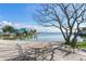 Relaxing waterfront patio with table and chairs, offering scenic views at 409 161St Ave, Redington Beach, FL 33708