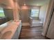 Bright bathroom featuring double vanity, a glass shower, and a separate bathtub at 4314 Pullet Ct, Lakewood Ranch, FL 34211