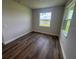 Bright bedroom featuring hardwood floors and a large window offering natural light at 4314 Pullet Ct, Lakewood Ranch, FL 34211