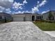 Charming single-story home boasts a paver driveway and a well-manicured lawn at 4314 Pullet Ct, Lakewood Ranch, FL 34211