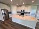 Modern kitchen with stainless steel appliances, a large island, and white cabinets at 4314 Pullet Ct, Lakewood Ranch, FL 34211