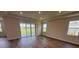 Spacious living room with hardwood floors and sliding glass doors leading to the backyard at 4314 Pullet Ct, Lakewood Ranch, FL 34211
