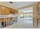 Kitchen undergoing renovation, featuring wood cabinets and a view into the adjacent living area at 4610 Bay Crest Dr, Tampa, FL 33615