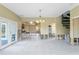 Open living area with high ceilings, and access to the kitchen and a spiral staircase. Under renovation at 4610 Bay Crest Dr, Tampa, FL 33615