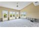 Living room with vaulted ceiling, large windows, and French doors. Currently under renovation at 4610 Bay Crest Dr, Tampa, FL 33615