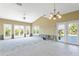 Bright living room with vaulted ceilings, and multiple sets of French doors leading outside. Currently under renovation at 4610 Bay Crest Dr, Tampa, FL 33615