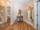 Light-filled entryway with hardwood floors and access to other rooms at 5246 Gato Del Sol Cir, Wesley Chapel, FL 33544