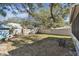 Large backyard with a wooden fence, patio furniture, and shed at 605 E Spruce St, Tarpon Springs, FL 34689