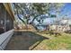 Expansive backyard showcasing shed, screened porch, and mature trees at 605 E Spruce St, Tarpon Springs, FL 34689