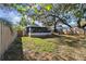 Large backyard with screened porch and lush green grass at 605 E Spruce St, Tarpon Springs, FL 34689