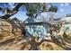 Quaint backyard shed nestled amongst trees, featuring a small patio area at 605 E Spruce St, Tarpon Springs, FL 34689