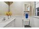 Clean bathroom with a single vanity and neutral decor at 605 E Spruce St, Tarpon Springs, FL 34689