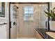Updated bathroom with a walk-in shower and granite countertop at 605 E Spruce St, Tarpon Springs, FL 34689