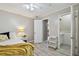 Cozy bedroom with a yellow blanket and a white nightstand at 605 E Spruce St, Tarpon Springs, FL 34689