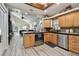 Open concept kitchen with stainless steel appliances and wood cabinets at 605 E Spruce St, Tarpon Springs, FL 34689