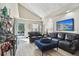 Bright living room with hardwood floors, leather sofas, and an open concept design at 605 E Spruce St, Tarpon Springs, FL 34689