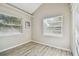 Well-lit home office with wood-look floors and two windows at 605 E Spruce St, Tarpon Springs, FL 34689