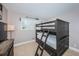 Cozy bedroom with a bunk bed, window with plantation shutters, and tiled floor at 6382 Palma Del Mar S Blvd # 123, St Petersburg, FL 33715