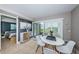 Small dining area with white table and chairs, near sliding door at 6382 Palma Del Mar S Blvd # 123, St Petersburg, FL 33715