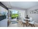 Bright dining area with white table and chairs and patio access at 6382 Palma Del Mar S Blvd # 123, St Petersburg, FL 33715