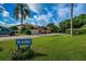 Condo building exterior with parking and landscaping at 6382 Palma Del Mar S Blvd # 123, St Petersburg, FL 33715