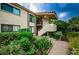 Attractive condo building with lush landscaping and walkway at 6382 Palma Del Mar S Blvd # 123, St Petersburg, FL 33715