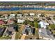 Aerial view of community with lake and numerous houses at 703 Elkhorn Rd, Sun City Center, FL 33573
