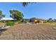 Well-maintained backyard with a screened enclosure, landscaping, and a neatly kept lawn at 703 Elkhorn Rd, Sun City Center, FL 33573