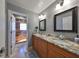 Double vanity bathroom with granite countertops and walk-in shower at 703 Elkhorn Rd, Sun City Center, FL 33573