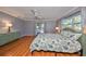 Main bedroom with hardwood floors and sliding doors to patio at 703 Elkhorn Rd, Sun City Center, FL 33573