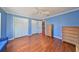 Blue bedroom with wood floors and lots of natural light at 703 Elkhorn Rd, Sun City Center, FL 33573