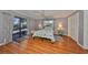 Bright bedroom with wood floors, sliding glass doors, and ample closet space at 703 Elkhorn Rd, Sun City Center, FL 33573