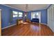 Blue bedroom with wood floors and window seat at 703 Elkhorn Rd, Sun City Center, FL 33573