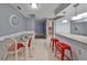 Elegant dining area features a glass-top table and red chairs at 703 Elkhorn Rd, Sun City Center, FL 33573