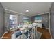 Bright dining room with white table and chairs, hardwood floors, and coastal artwork at 703 Elkhorn Rd, Sun City Center, FL 33573