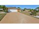 House exterior featuring a single-car garage and landscaped yard at 703 Elkhorn Rd, Sun City Center, FL 33573