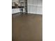 Spacious garage featuring white cabinetry and a smooth, sealed floor for easy maintenance at 703 Elkhorn Rd, Sun City Center, FL 33573