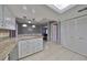 Open kitchen with granite island and stainless steel appliances at 703 Elkhorn Rd, Sun City Center, FL 33573