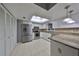 Updated kitchen with white cabinets, granite counters, and breakfast bar at 703 Elkhorn Rd, Sun City Center, FL 33573