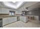 Eat-in kitchen with white cabinets, granite counters, and a breakfast nook at 703 Elkhorn Rd, Sun City Center, FL 33573