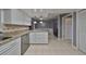 Kitchen boasts granite countertops and white cabinets at 703 Elkhorn Rd, Sun City Center, FL 33573