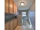 Laundry room with built-in cabinets and a washer and dryer at 703 Elkhorn Rd, Sun City Center, FL 33573