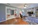 Open living room with hardwood floors, built-in shelving, and a view to the dining area at 703 Elkhorn Rd, Sun City Center, FL 33573