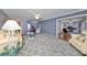 Open living room with hardwood floors, a ceiling fan, and access to other rooms at 703 Elkhorn Rd, Sun City Center, FL 33573
