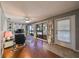 Relaxing living area features a comfy recliner, large windows, and hardwood floors at 703 Elkhorn Rd, Sun City Center, FL 33573