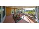 Bright screened porch featuring a glass table and wicker seating at 703 Elkhorn Rd, Sun City Center, FL 33573