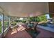 Relaxing screened porch with seating area and glass table at 703 Elkhorn Rd, Sun City Center, FL 33573