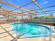 Inviting kidney-shaped pool with screened enclosure at 7216 Orchid Lake Rd, New Port Richey, FL 34653