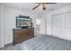 Comfortable bedroom featuring a wooden dresser with flatscreen TV and ceiling fan at 8272 Artisan Way, Seminole, FL 33777